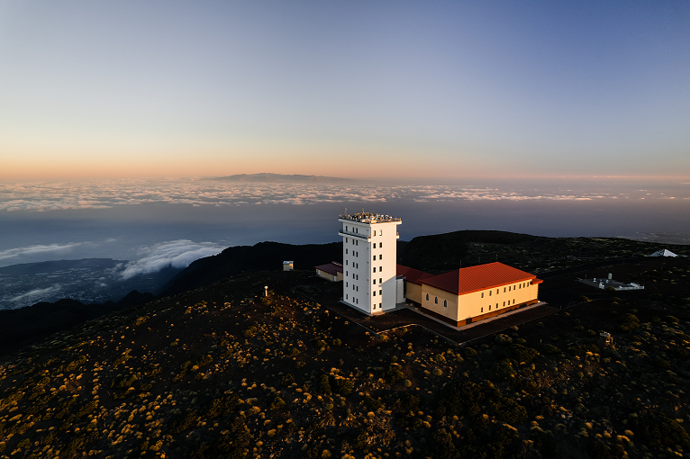 Figure 1. Overhead view of the Izaña Observatory and the sea of clouds caused by the thermal inversion in the lower troposphere atmosphere, which takes place in the Canary Islands region. This inversion occurs most days of the year, preventing air masses with anthropogenic emissions from reaching the observatory (©ICOS-ERIC).
